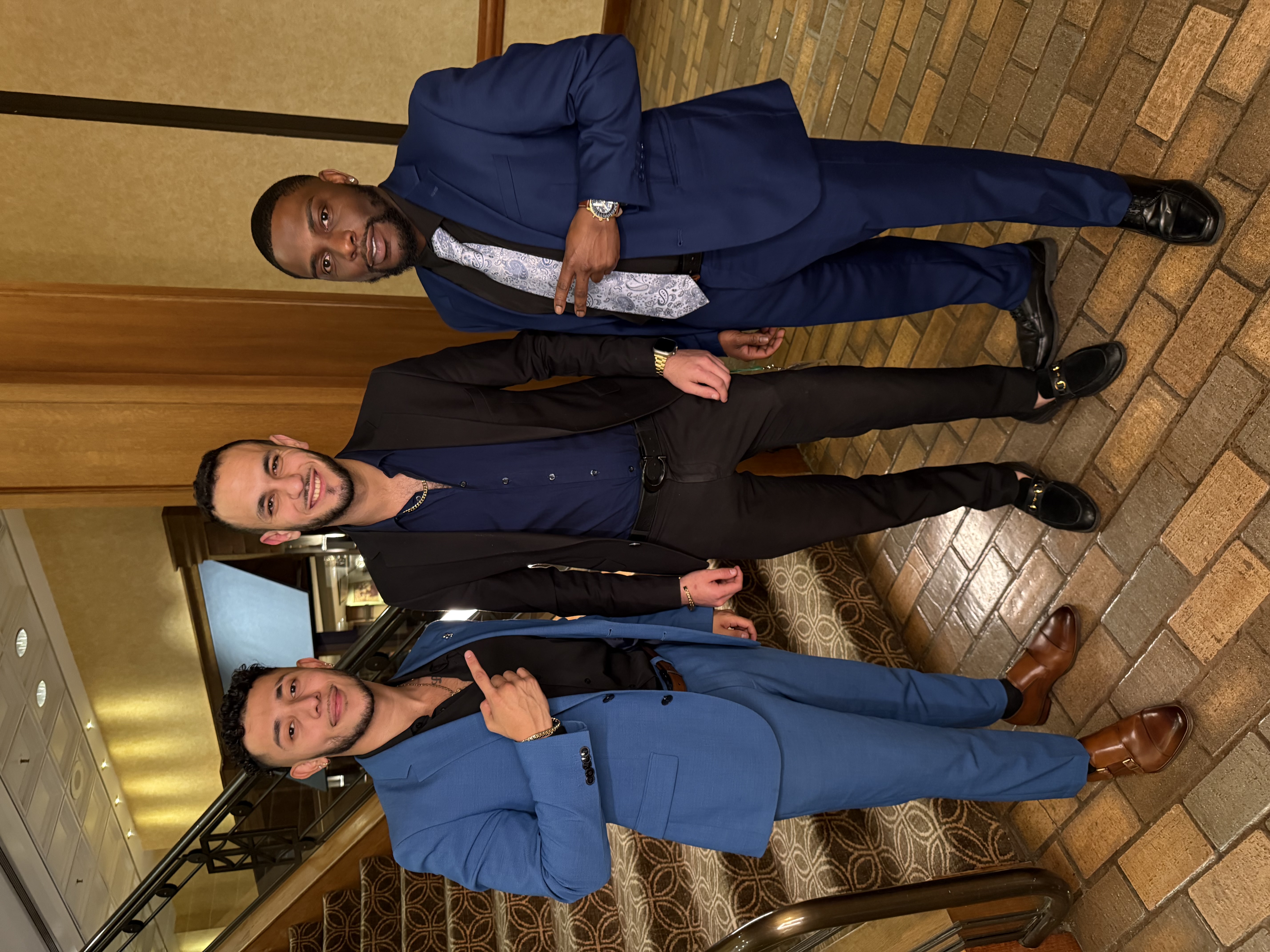 Fine Line Vision leaders dressed in suits at a hotel event